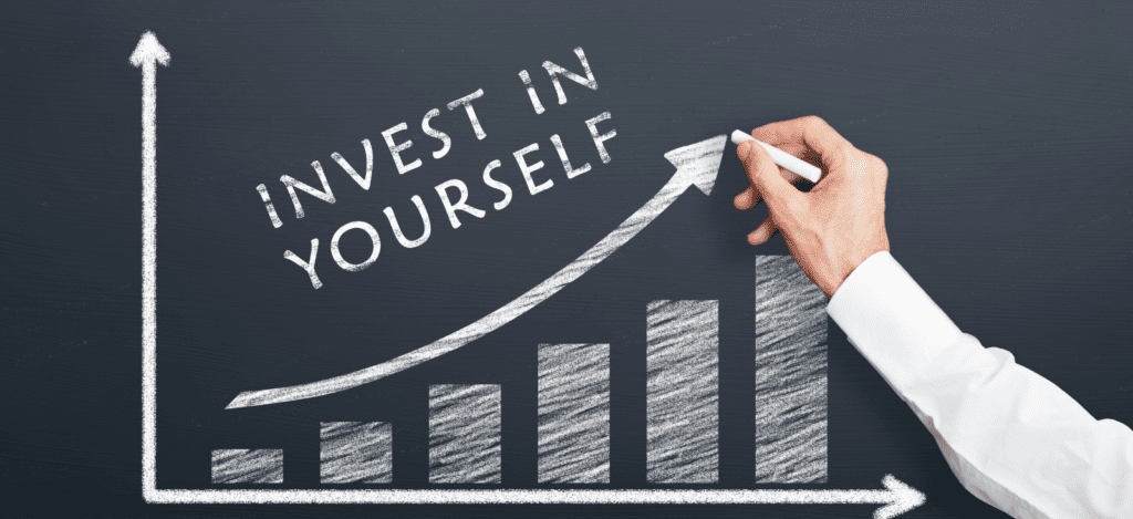 Consultant writing on blackboard invest in yourself