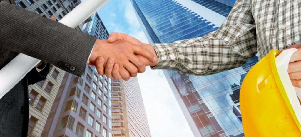 a business consultant and a construction business owner shaking hands